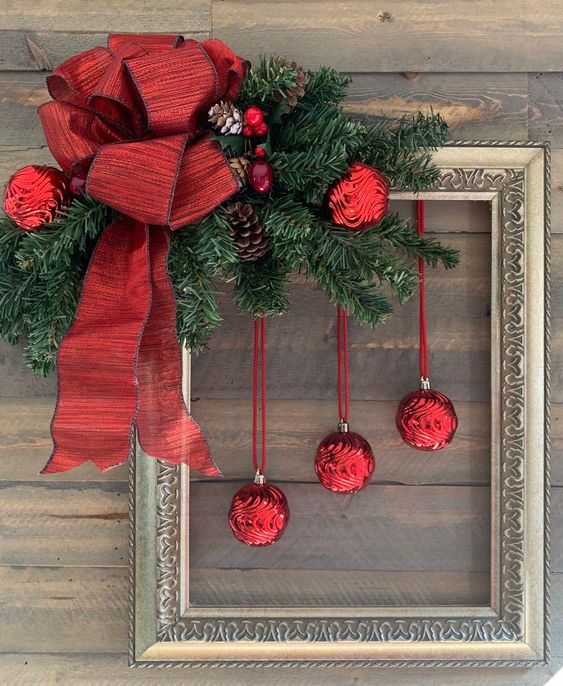 https://www.digsdigs.com/photos/2011/11/a-bold-Christmas-decoration-of-a-vintage-frame-evergreens-red-ornaments-pinecones-and-a-large-red-bow-is-amazing.jpg