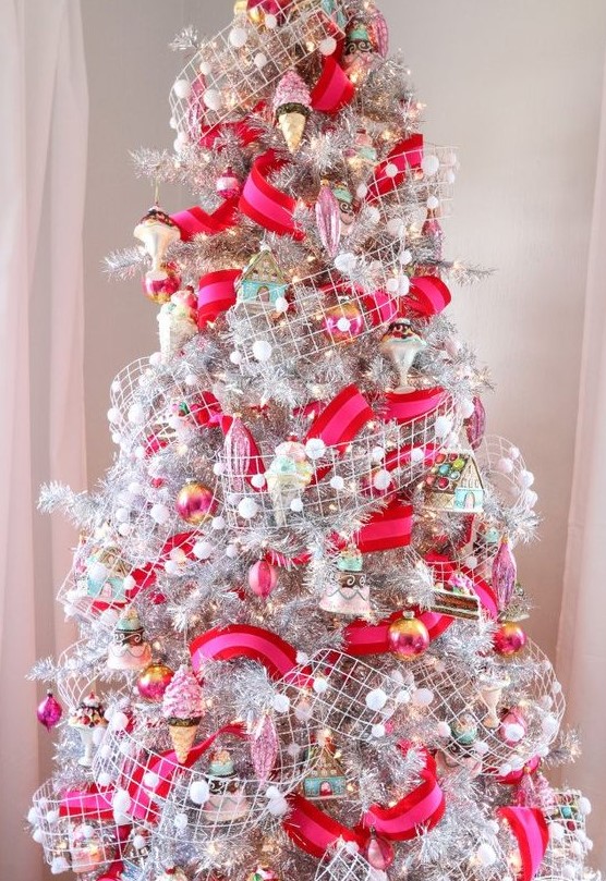 a bold and fun Christmas tree in silver, with hot pink and red ribbons, snowy pompom ribbons, colorful ornaments and ice cream ones