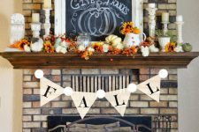 a bold vintage Thanksgiving mantel with berries, pumpkins and blooms – all faux ones, candles and a chalkboard sign