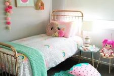 a bright and pastel kid’s room with colorful garlands, bedding, toys, rugs and cool foodie pillows