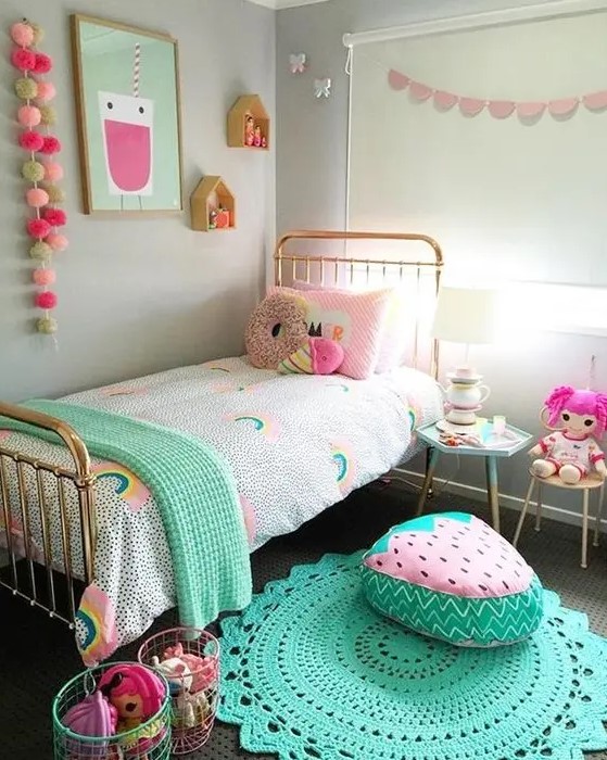 a bright and pastel kid's room with colorful garlands, bedding, toys, rugs and cool foodie pillows