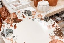 a creative pumpkin and leaf print plate in orange, brown and grey is a lovely idea for Thanksgiving, it will accent your food