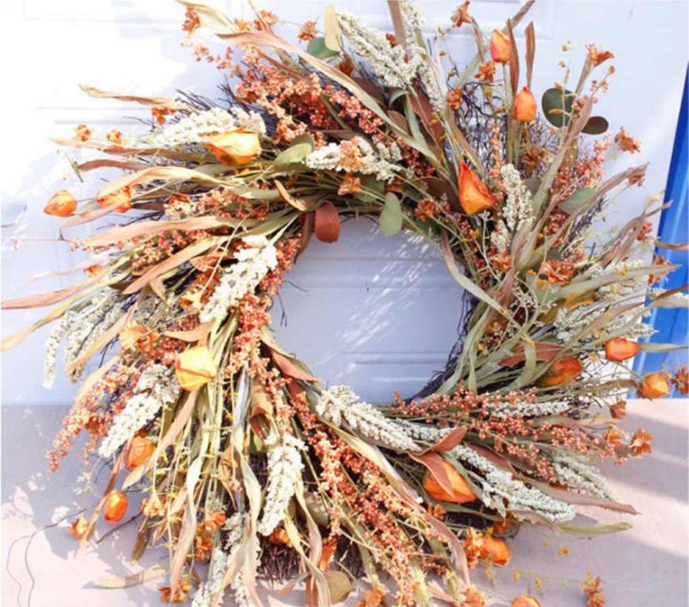 a fantastic harvest Thanksgiving wreath of herbs, leaves, greenery, dried blooms and wheat looks very natural and organic