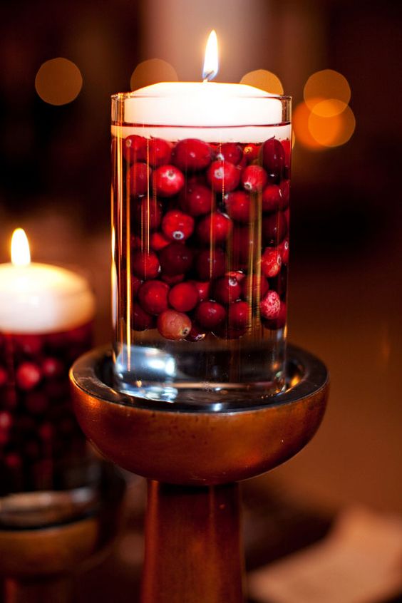 a glass with cranberries and a floating candle on top will make your Thanksgiving or Christmas cooler and cozier