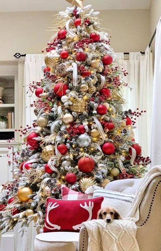 a gorgeous Christmas tree with gold, red and clear ornaments, berry branches, twigs and ribbons