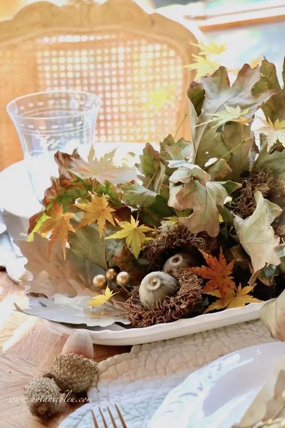 a lovely all-natural Thanksgiving centerpiece of fall leaves, acorns, fruits and other stuff can be made last minute