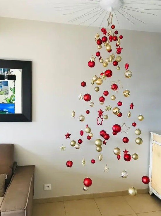 a modern floating Christmas tree of red and gold ornaments, baubles and stars, is a gorgeous idea
