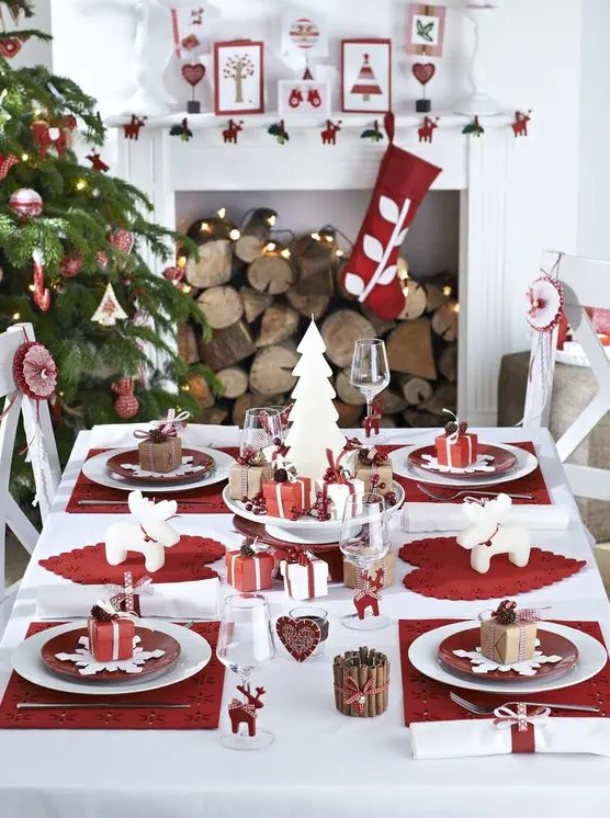 a modern red and white Christmas table setting, red and wwhite ornaments and stockings