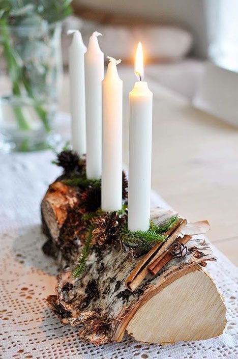 a pretty woodland candelabra of a tree stump, evergreens and cinnamon and some candles is a gorgeous idea for both fall and winter decor