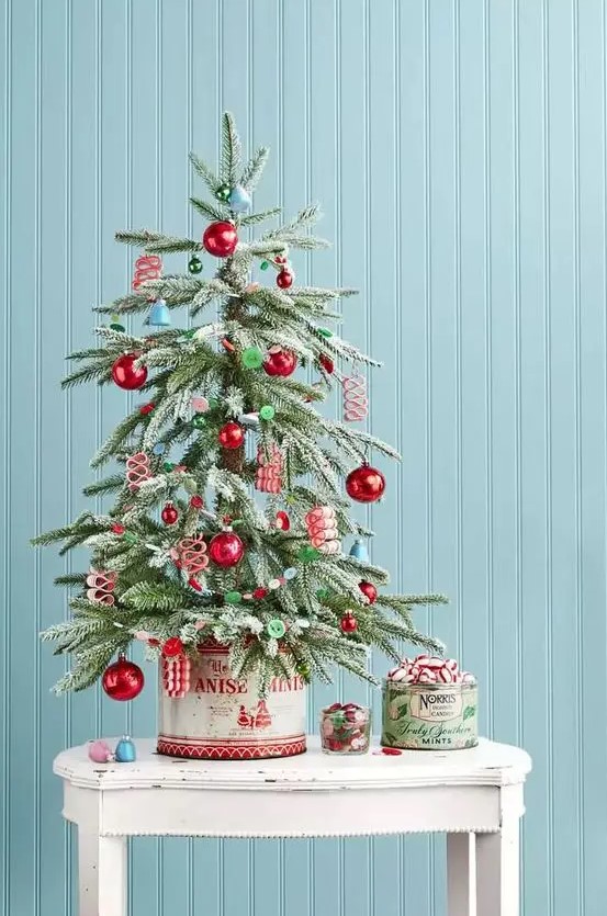 a retro-inspired tabletop Christmas tree with blue bells, red and green ornaments, buttons is a lovely idea for your space