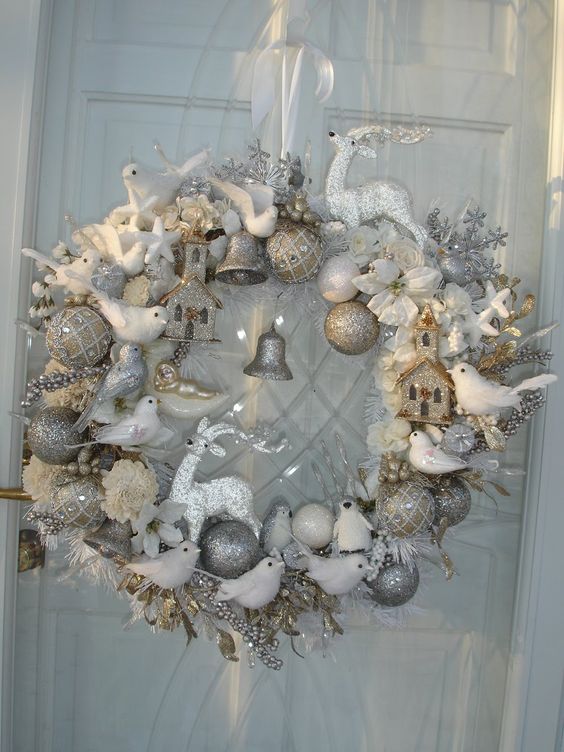 a silver Christmas wreath of silver ornaments, white faux birds and deer and silver glitter bells looks charming and vintage chic
