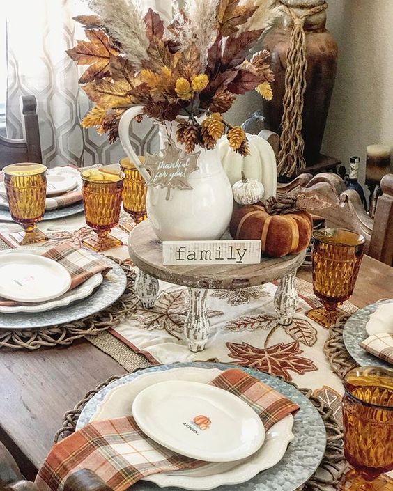 a silver patterned plate, a white patterned one and a white pumpkin printed plate with a plaid napkin are amazing for Thanksgiving