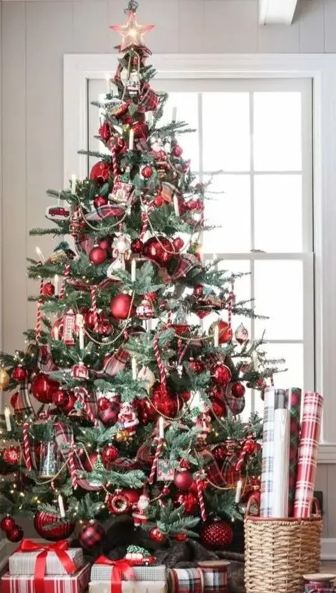 a vintage-inspired Christmas tree with red ornaments, lights and candy candes looks bold and catchy
