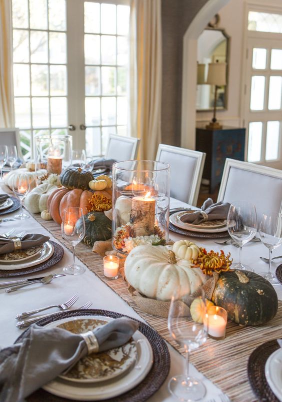 an all-natural Thanksgiving centerpiece of lots of heirloom pumpkins and candles is a lovely idea that requires no effort at all
