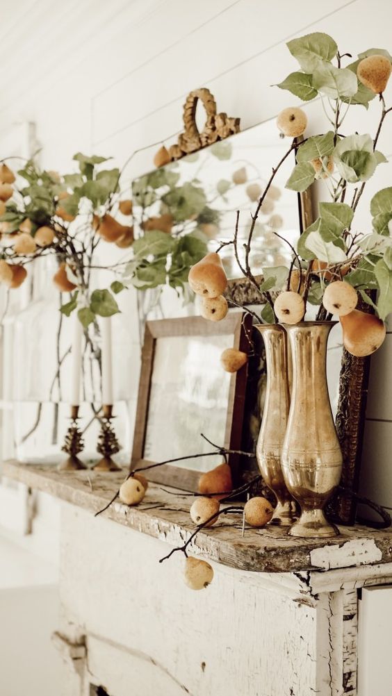 beautiful greenery arrangements with pears and apples and candles will make your mantel ultimately beautiful and cozy