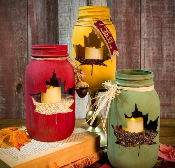 fabulous fall or Thanksgiving candle lanterns - bright jars with maple leaf windows and corn and coffee plus candles inside