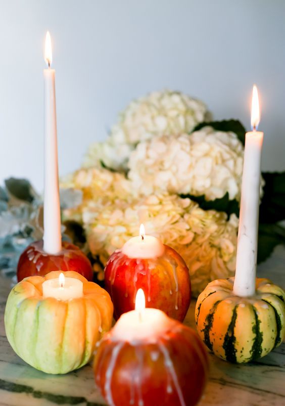 mini pumpkins and apples as candleholders are perfection for Thanksgiving and will add a natural feel to the space