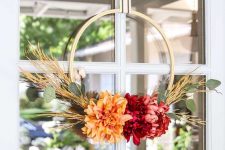 such a cute and bright fall or Thanksgiving wreath with bold blooms, greenery and wheat is a very bold and easy to DIY piece