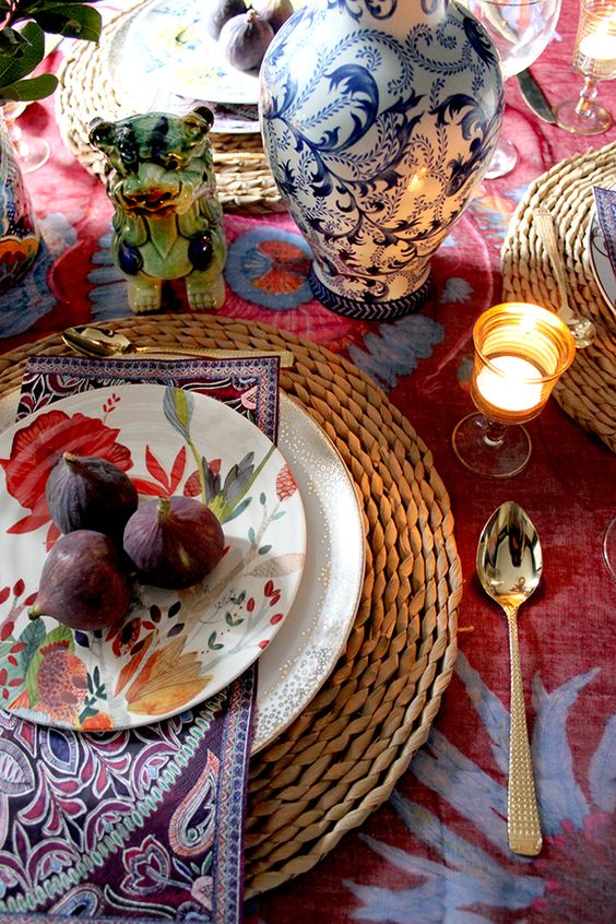 woven placemats, a silver polka dot plate, a bright floral print one and a purple patterned napkin for a bright Thanksgiving table