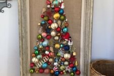 a Christmas tree wall art of bright vintage Christmas ornaments is a super cool and bold idea to repeat