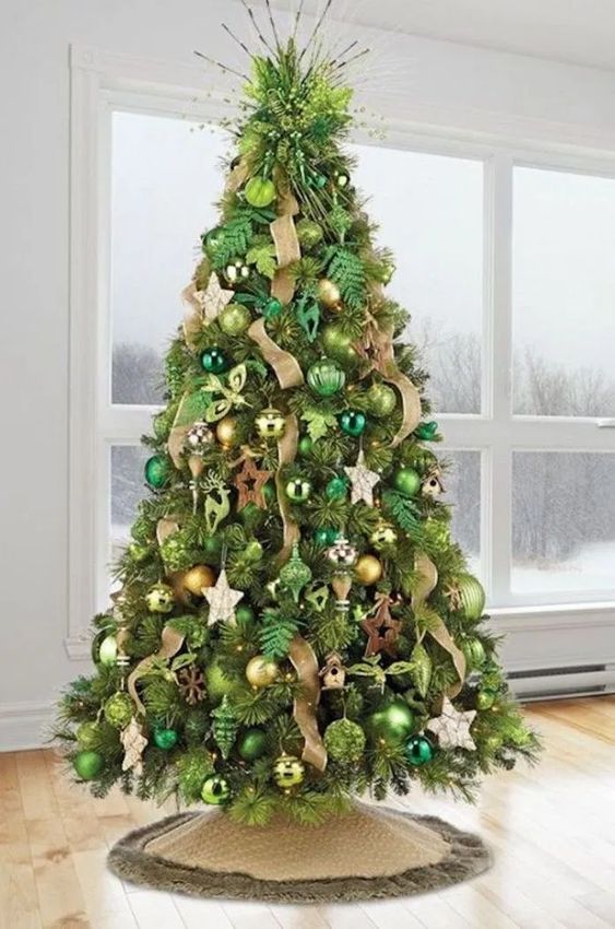 a Christmas tree with bold green and emerald ornaments, gold and copper ones, ribbons and wooden stars