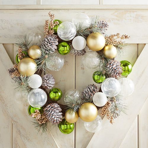 a Christmas wreath made of white and gild ornaments, snowy pinecones and snowy evergreens