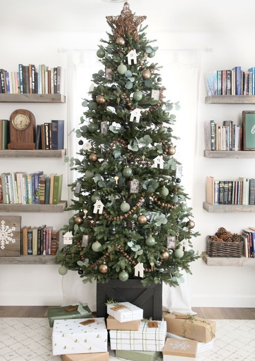 a beautiful cottage Christmas tree with brown and green ornaments, wooden bead garlands, leaves and a vine star on top