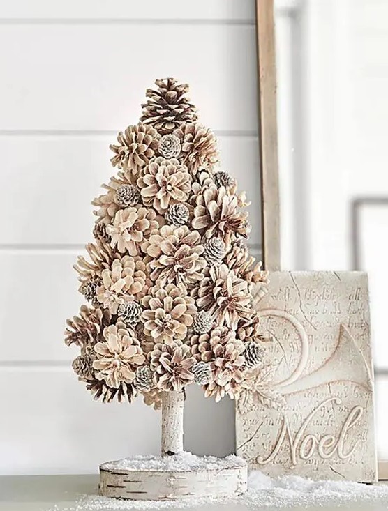 a bleached pinecone Christmas tree on a stand is a very cool and cozy farmhouse or woodland decor idea for winter