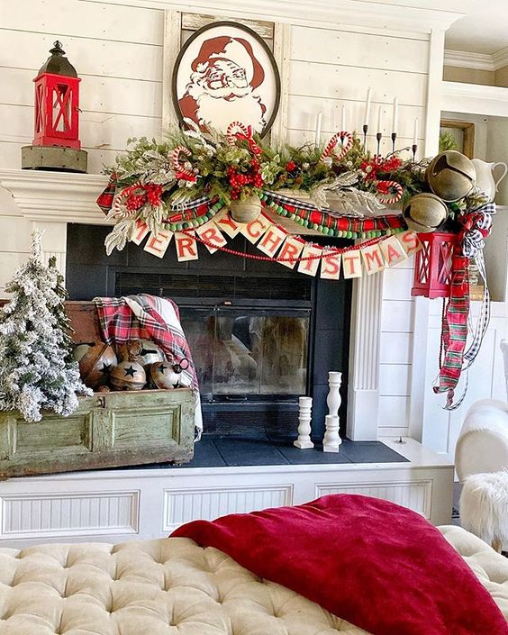 a bold retro Christmas mantel with plaid and wooden bead garlands, an evergreen one, oversized bells and tall and thin candles