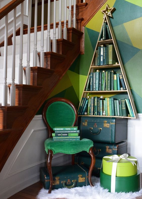 a bookshelf shaped as a Christmas tree, green books inside make it look more like a real Christmas tree