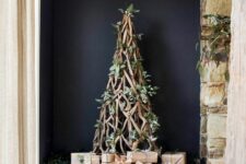 a branch Christmas tree decorated with greenery and white blooms is a very organic and eye-catchy idea to rock