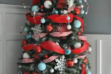 a colorful Christmas tree done in turquoise and red, with white and silver ornaments and beads plus a star on top