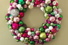 a colorful Christmas wreath of ornaments of green, pink, silver, blush balls and snowflakes