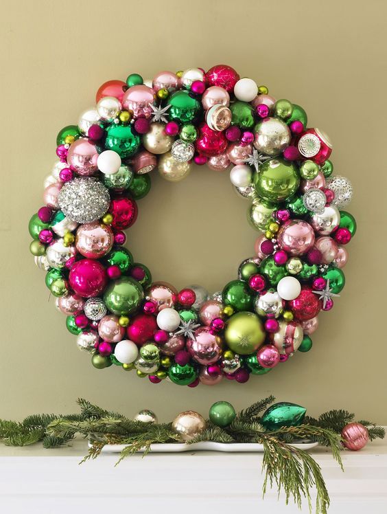 a colorful Christmas wreath of ornaments of green, pink, silver, blush balls and snowflakes