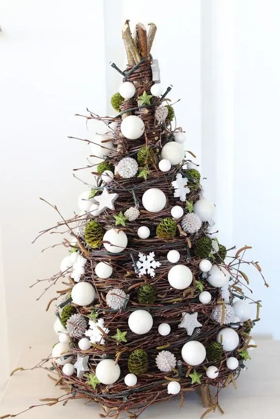 a cone shaped Christmas tree made of twigs, vine, moss, white beads, stars and pearls is an amazing idea for the holidays