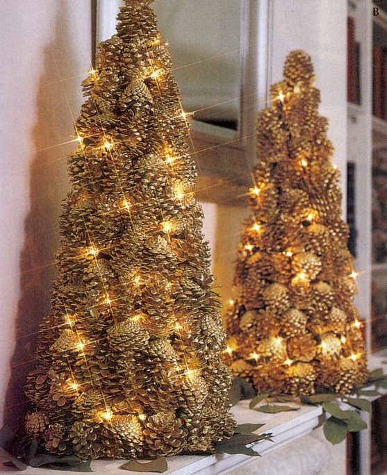 a couple of gilded pinecone Christmas trees decorated with lights look very festive and interesting