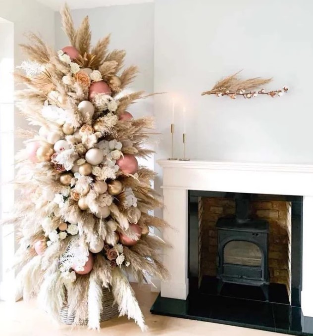 a creamy color pampas grass tree decorated with rose gold, gold and white ornaments plus blooms looks heavenly beautiful