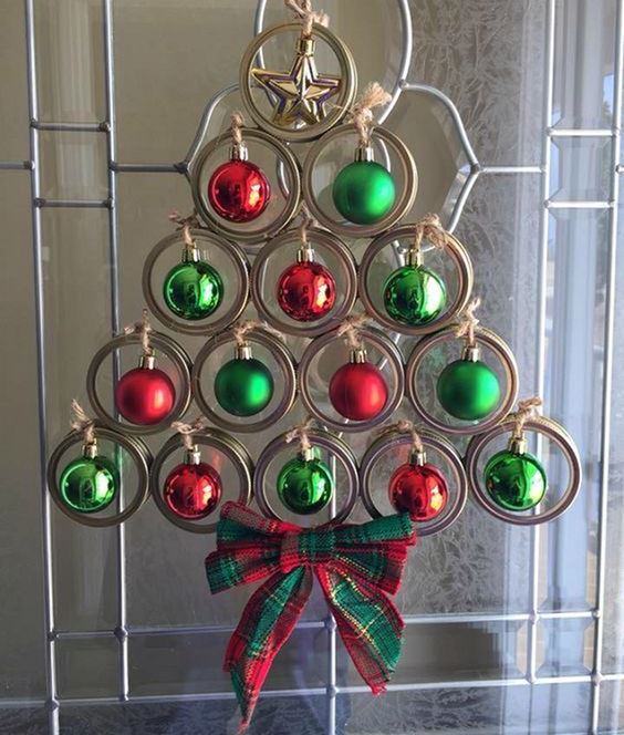 a creative Christmas tree of jar lids, green and red Christmas ornamerns and a plaid bow