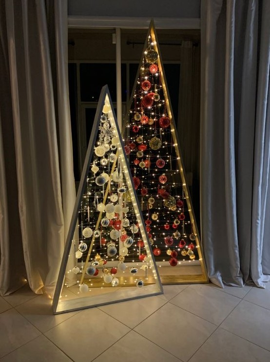 a duo of frame christmas tree with lights, white and silver and red and gold ornaments is a super creative solution for the holidays