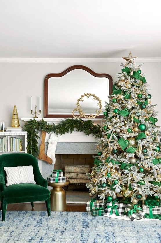 a fabulous Christmas space with an emeralf velvet chair, an evergreen pre-lit garland, a flocked Christmas tree with emerald ribbons and ornaments, beads and lights