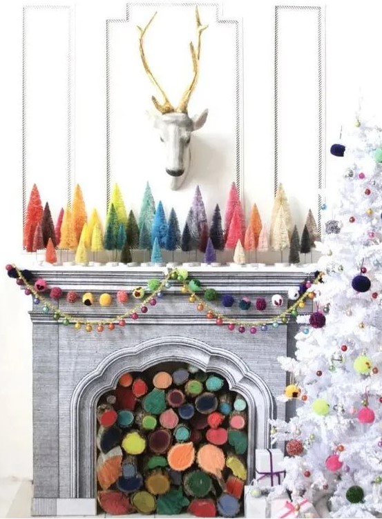 a fireplace filled with colorful firewood and matching bright bottle brush trees plus colorful felt garlands and bright pompoms on the tree