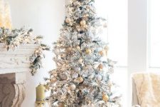 a flocked Christmas tree with a snowflake topper pastel and yellow and silver ornaments looks refined