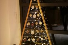 a frame Christmas tree with lights and white and brown ornaments plus a star topper is a cool idea for winter holidays