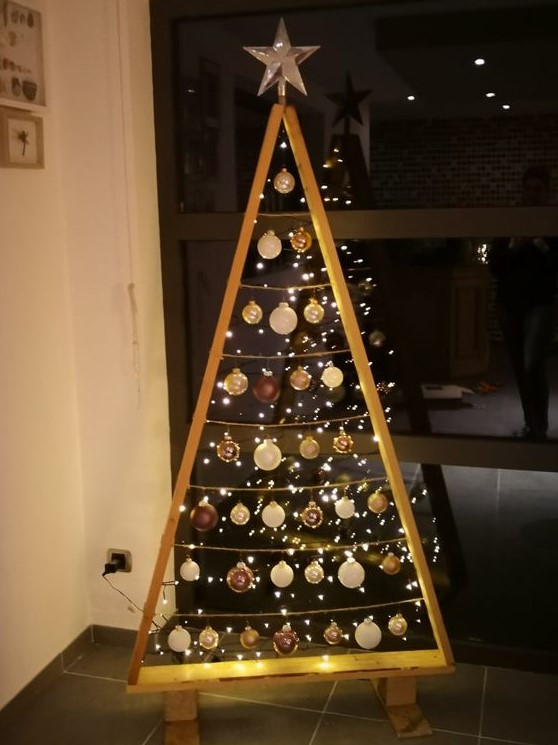 a frame Christmas tree with lights and white and brown ornaments plus a star topper is a cool idea for winter holidays