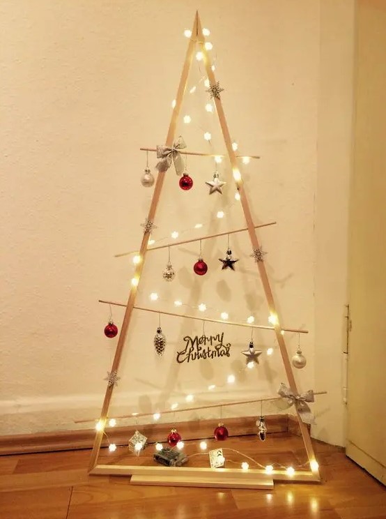 a frame Christmas tree with lights, various ornaments, bows and calligraphy is a cool idea for the holidays