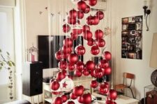 a large floating Christmas tree of matte and shiny Christmas ornaments and a couple of large white ones