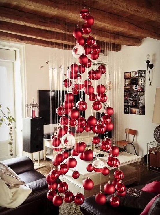 a large floating Christmas tree of matte and shiny Christmas ornaments and a couple of large white ones