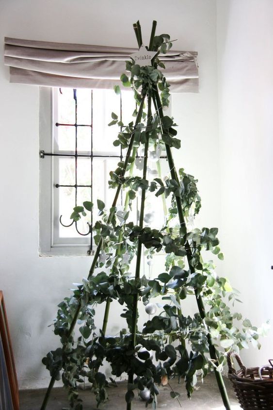 a lovely natural christmas tree composed of some sticks, greenery and a single star on top will match many modenr interiors
