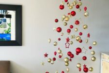 a modern floating Christmas tree of red and gold ornaments, baubles and stars, is a gorgeous idea