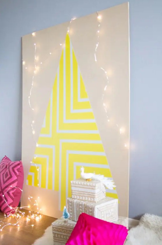 a neon yellow geometric Christmas tree on a plywood sheet with lights around for a colorful space